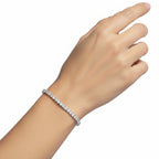 My Store 4 round brilliant diamond tennis bracelet in a low-profile four-prong setting worn on a woman's wrist