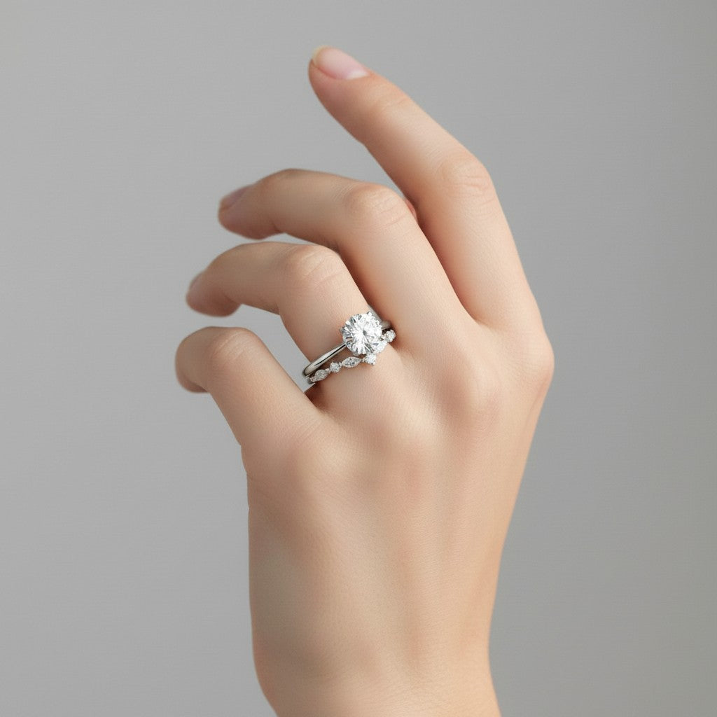 My Store 4 round solitaire engagement ring with a marquise diamond chevron wedding band on a woman's finger