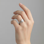 My Store 4 round solitaire engagement ring with a marquise diamond chevron wedding band on a woman's finger