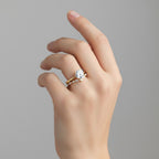 My Store 4 round solitaire engagement ring with a marquise diamond chevron wedding band on a woman's finger.