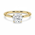 My Store 4 classic round cut solitaire engagement ring featuring a brilliant diamond on a polished yellow gold band.