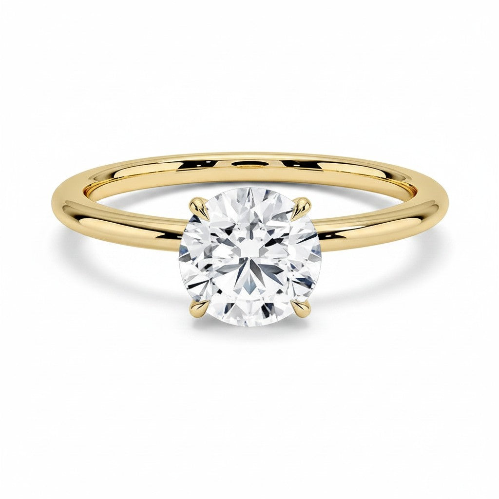 My Store 4 classic round cut solitaire engagement ring featuring a brilliant diamond on a polished yellow gold band.