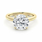 My Store 4 round cut solitaire engagement ring in yellow gold with a unique compass-prong setting on a white background.