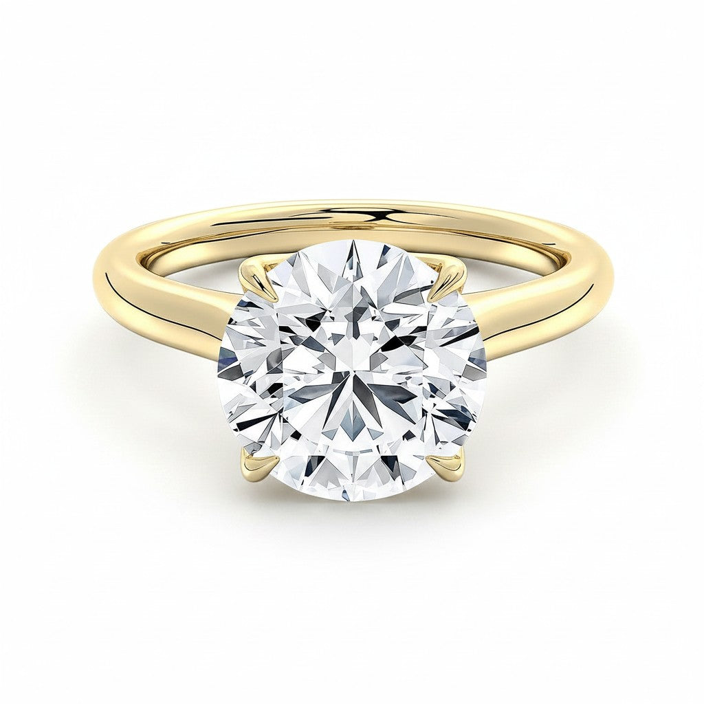 My Store 4 round cut solitaire engagement ring in yellow gold with a unique compass-prong setting on a white background.