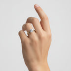 My Store 4 round solitaire engagement ring and micro-pavé eternity band set in 18K yellow gold worn on a hand.