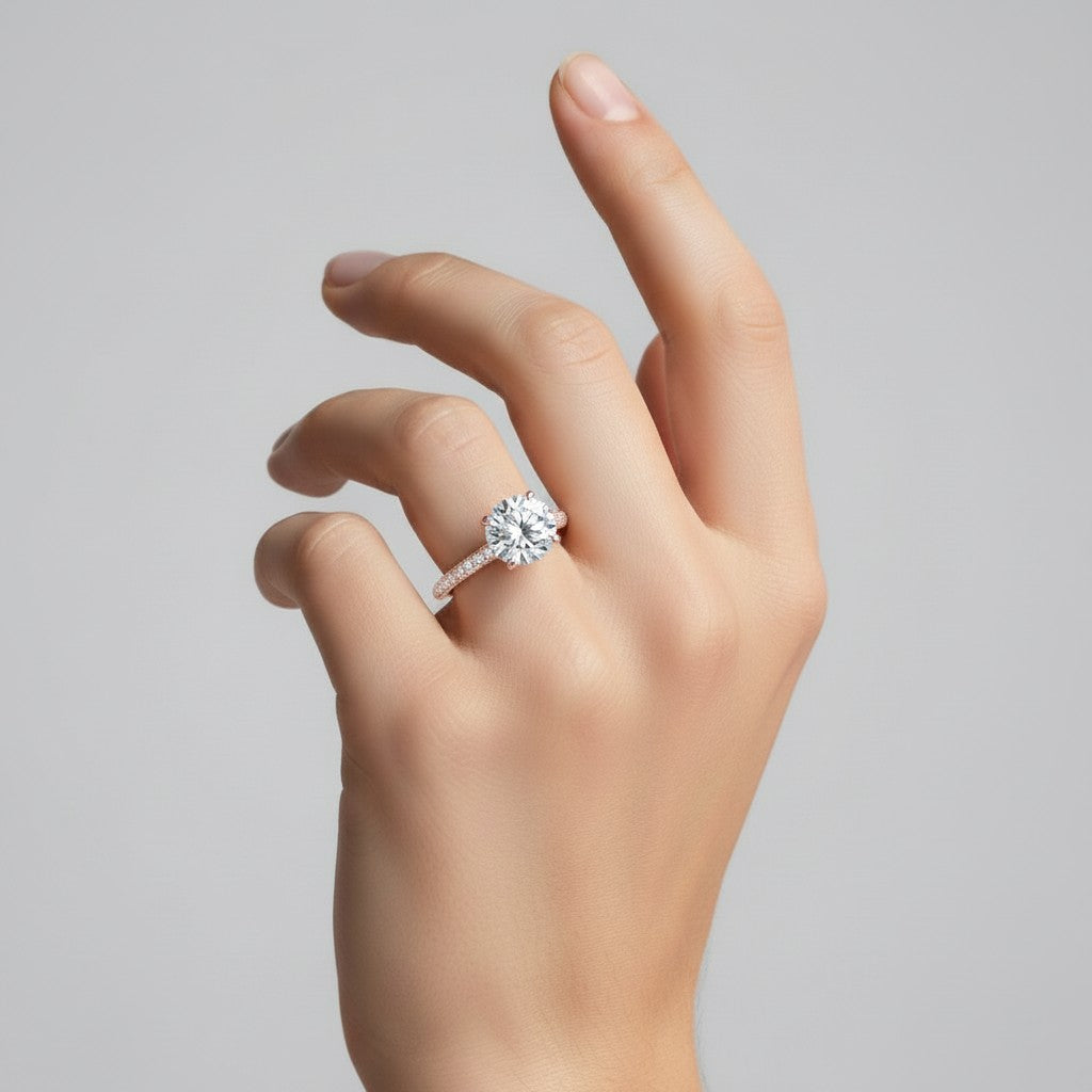 My Store 4 round cut solitaire engagement ring with a triple-row micro-pavé band on a woman's hand.