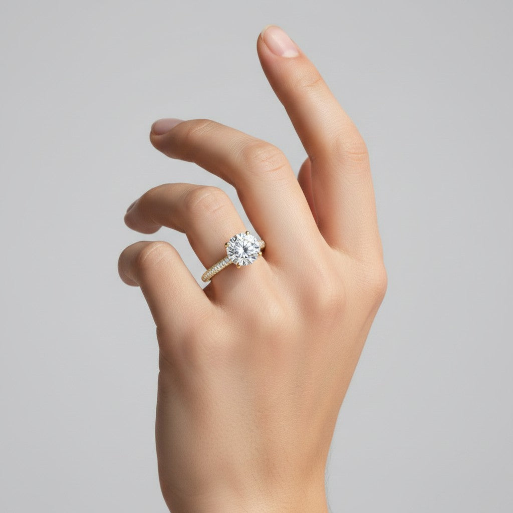 My Store 4 round cut solitaire engagement ring with a triple-row micro-pavé band on a woman's finger