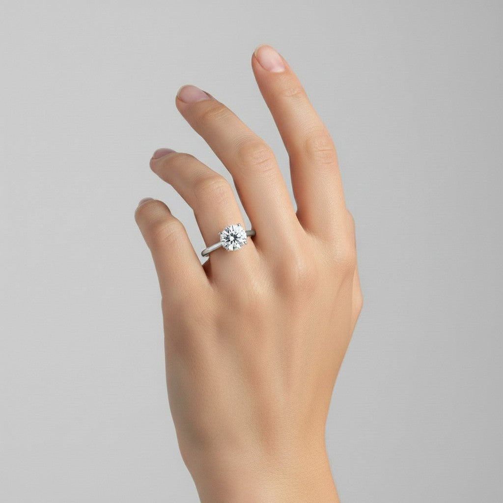 My Store 4 round cut solitaire engagement ring in white gold with a 4-prong setting on a woman's hand
