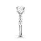 My Store 4 round cut solitaire engagement ring in white gold with a triple-row micro-pavé diamond band, side view.