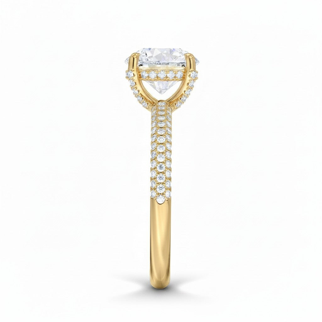 My Store 4 round cut solitaire engagement ring in yellow gold with a triple-row micro-pavé diamond band, side view.