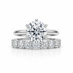 My Store 4 round tulip solitaire engagement ring and shared-prong eternity band set in polished white gold.