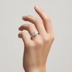 My Store 4 three-stone engagement ring with a round center diamond and micro-pavé band on a woman's hand.