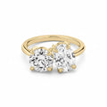 My Store 4 Toi et Moi engagement ring featuring a round and oval diamond on a polished 18K yellow gold band.
