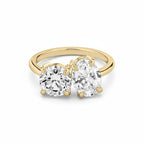 My Store 4 Toi et Moi engagement ring featuring a round and oval diamond on a polished 18K yellow gold band.