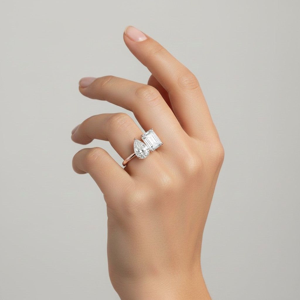 My Store 4 Toi et Moi ring featuring a pear and radiant cut diamond on a polished solid gold band worn on a hand