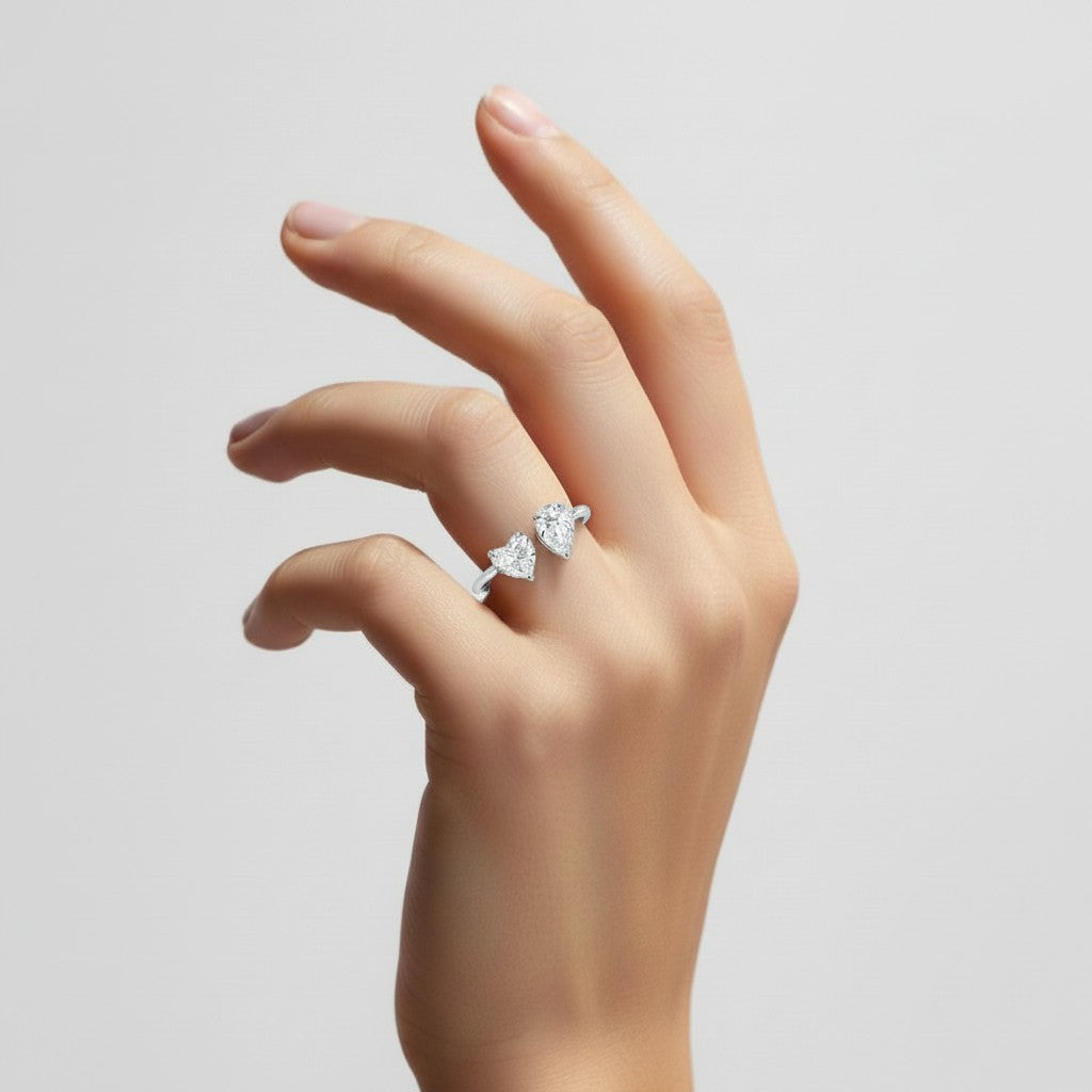 My Store 4 18K solid gold Toi et Moi ring featuring a pear and heart-cut lab-grown diamond on a woman's finger.