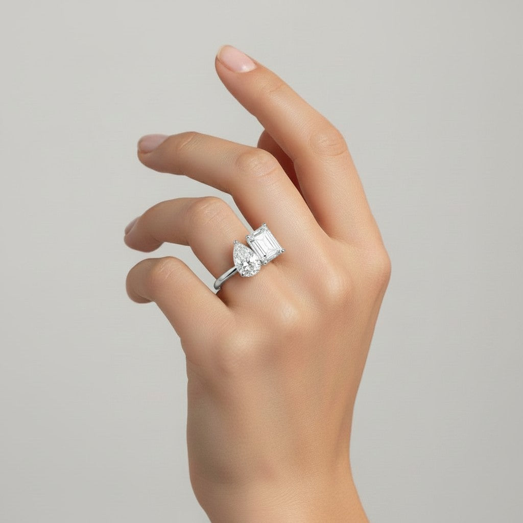 My Store 4 Toi et Moi ring featuring a pear and radiant cut diamond set on a polished gold band on a hand