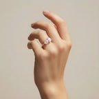 My Store 4 Toi et Moi engagement ring featuring a round and oval diamond on a polished yellow gold band on a hand.