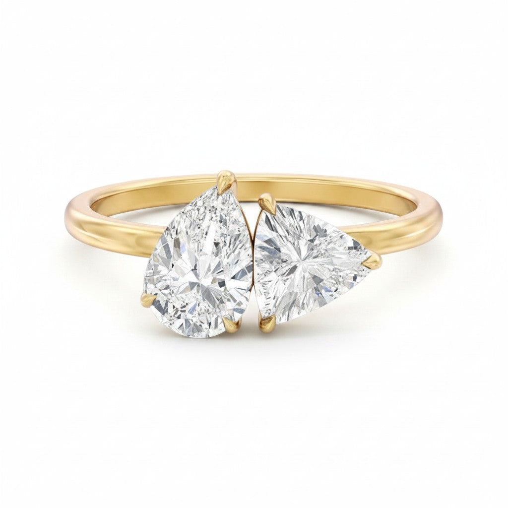 My Store 4 Toi et Moi engagement ring featuring a pear and trillion cut diamond set in 18K yellow gold.
