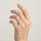 My Store 4 Toi et Moi engagement ring with round and oval diamonds on a pavé gold band worn on a woman's hand