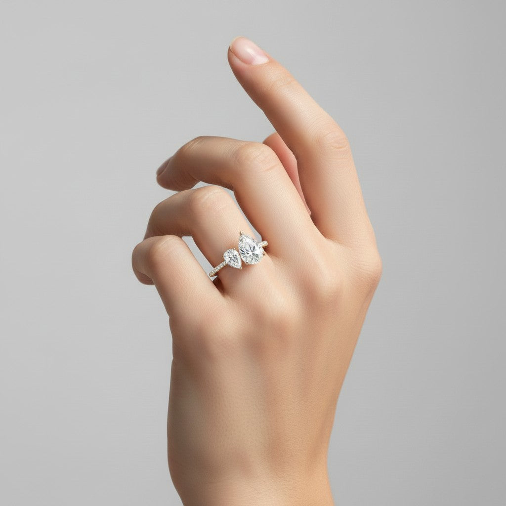 My Store 4 Toi et Moi engagement ring with dual pear-cut diamonds on a micro-pavé solid gold band worn on a finger