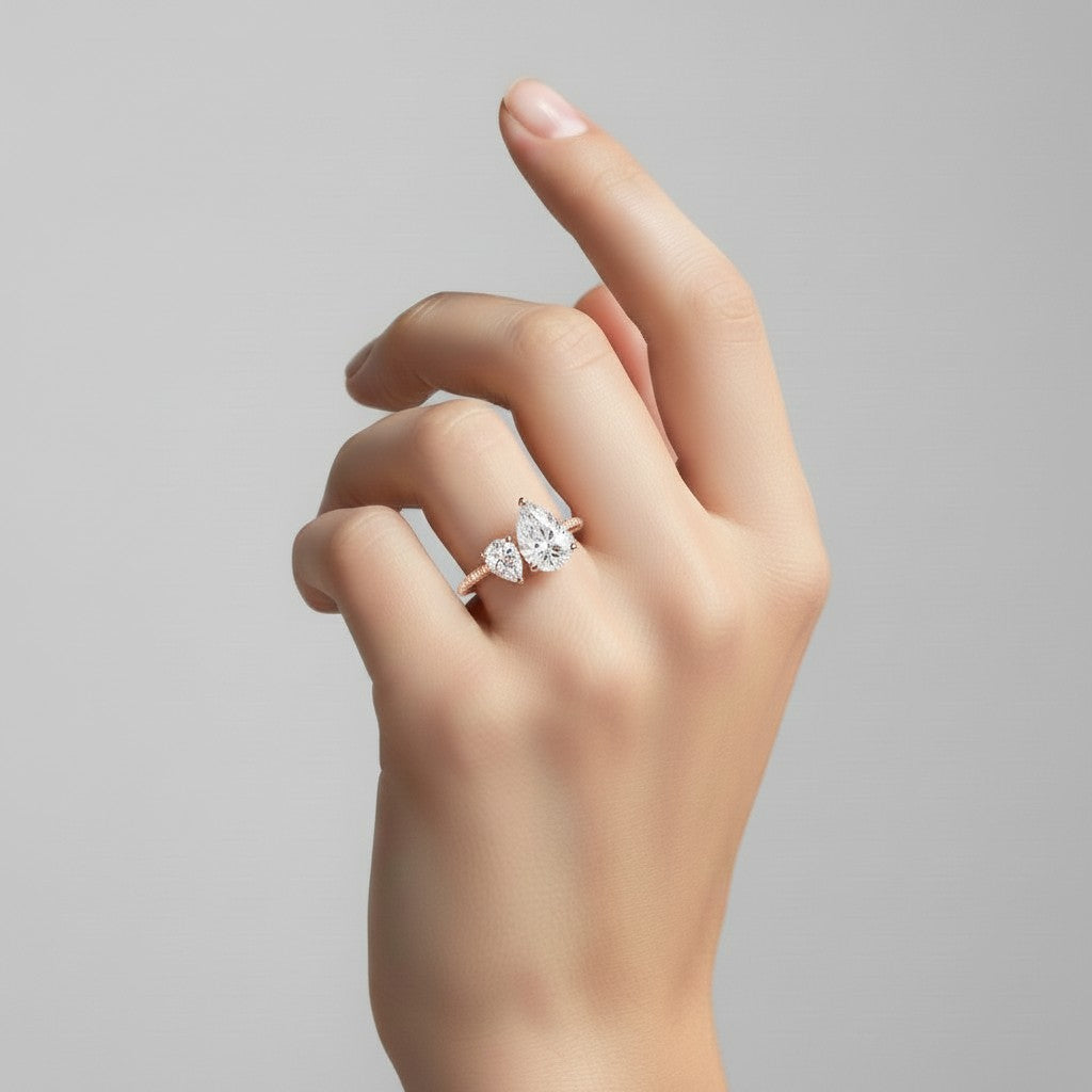 My Store 4 Toi et Moi engagement ring featuring two pear-cut diamonds on a pavé solid gold band worn on a hand