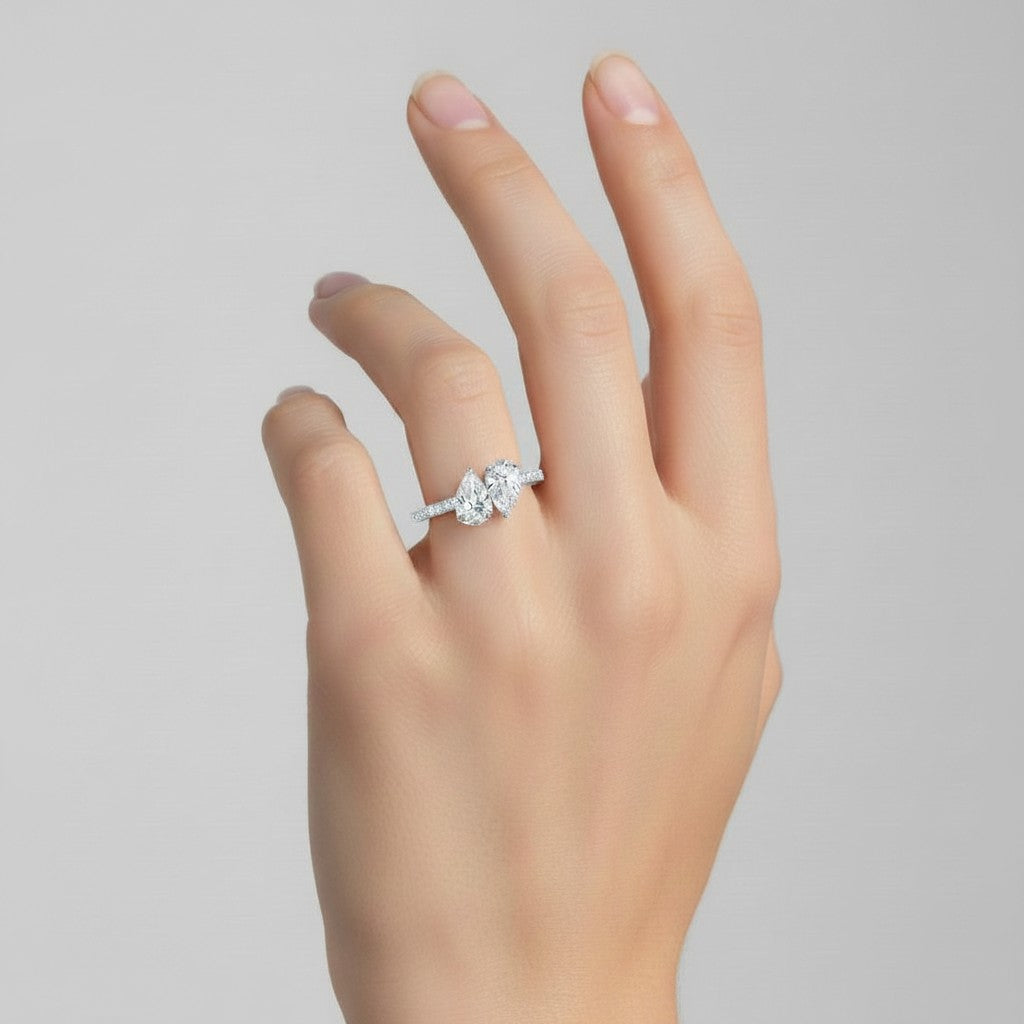 My Store 4 Toi et Moi engagement ring with dual pear-cut diamonds and a micro-pavé band on a woman's finger.