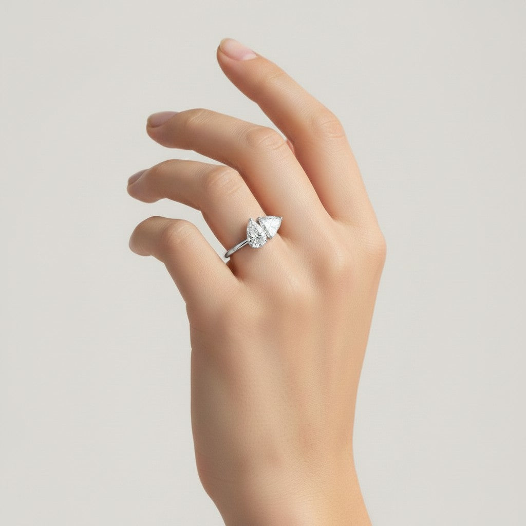My Store 4 Toi et Moi engagement ring with pear and trillion cut diamonds on a sleek white gold band on a hand