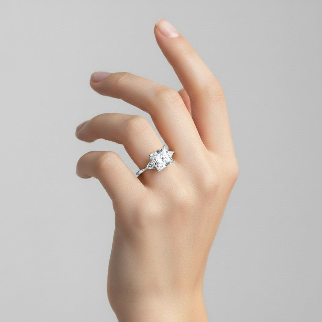 My Store 4 18K solid gold trilogy engagement ring featuring a princess-cut lab diamond and trilliant side stones.