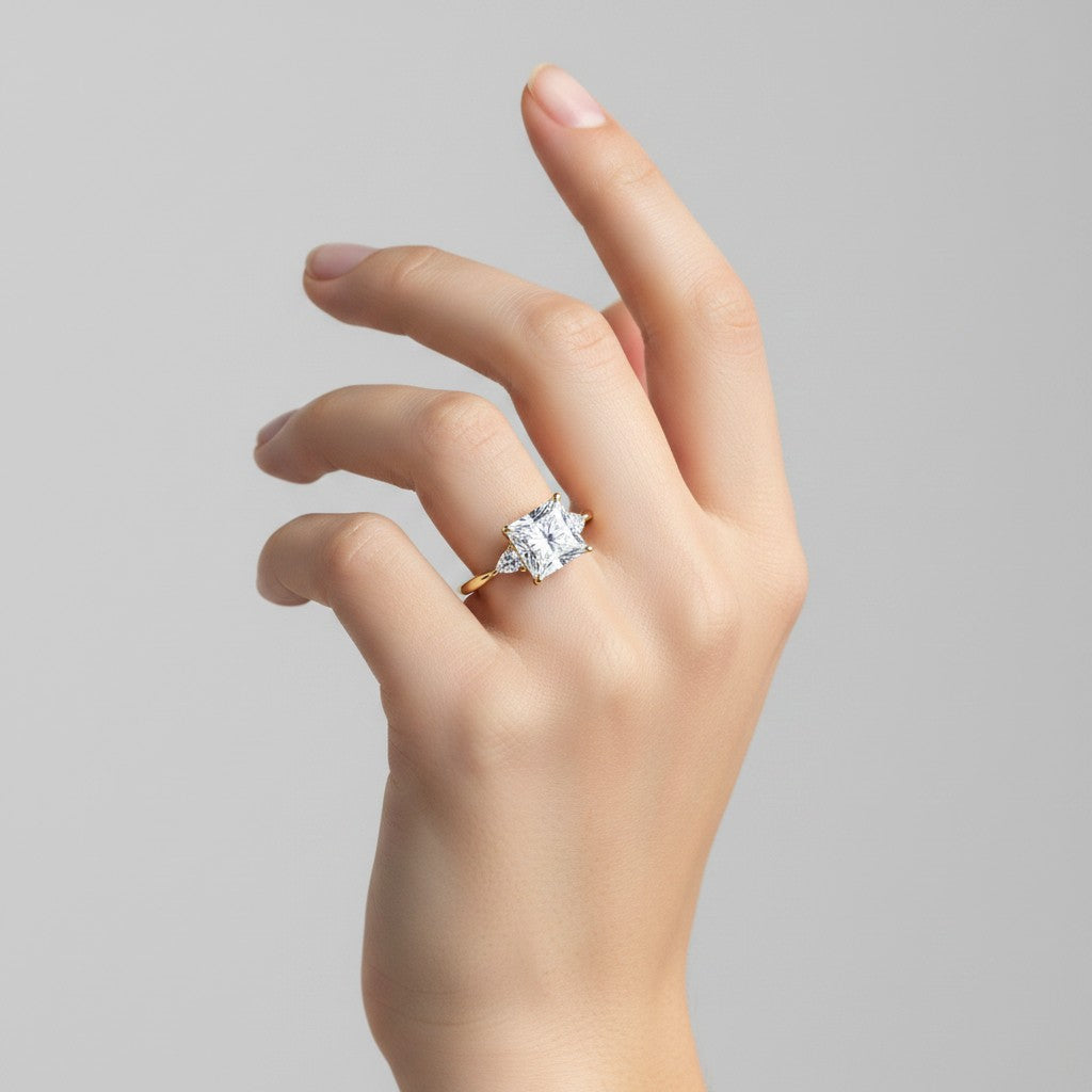 My Store 4 18K solid gold trilogy engagement ring featuring a princess-cut lab diamond and trilliant side stones.