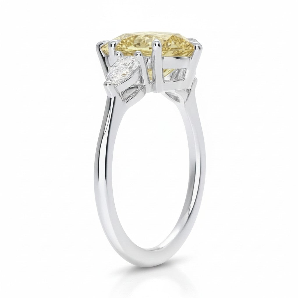 My Store 4 18K solid gold trilogy ring featuring a fancy yellow pear-cut lab-grown diamond and side stones.