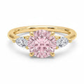My Store 4 18K solid gold trilogy ring featuring a central fancy pink pear-cut diamond with two side pear diamonds.