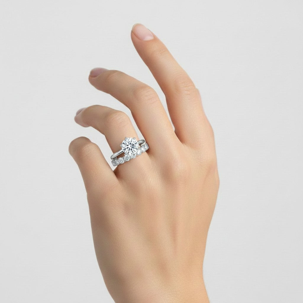 My Store 4 round tulip solitaire engagement ring and eternity band set worn on a finger in white gold