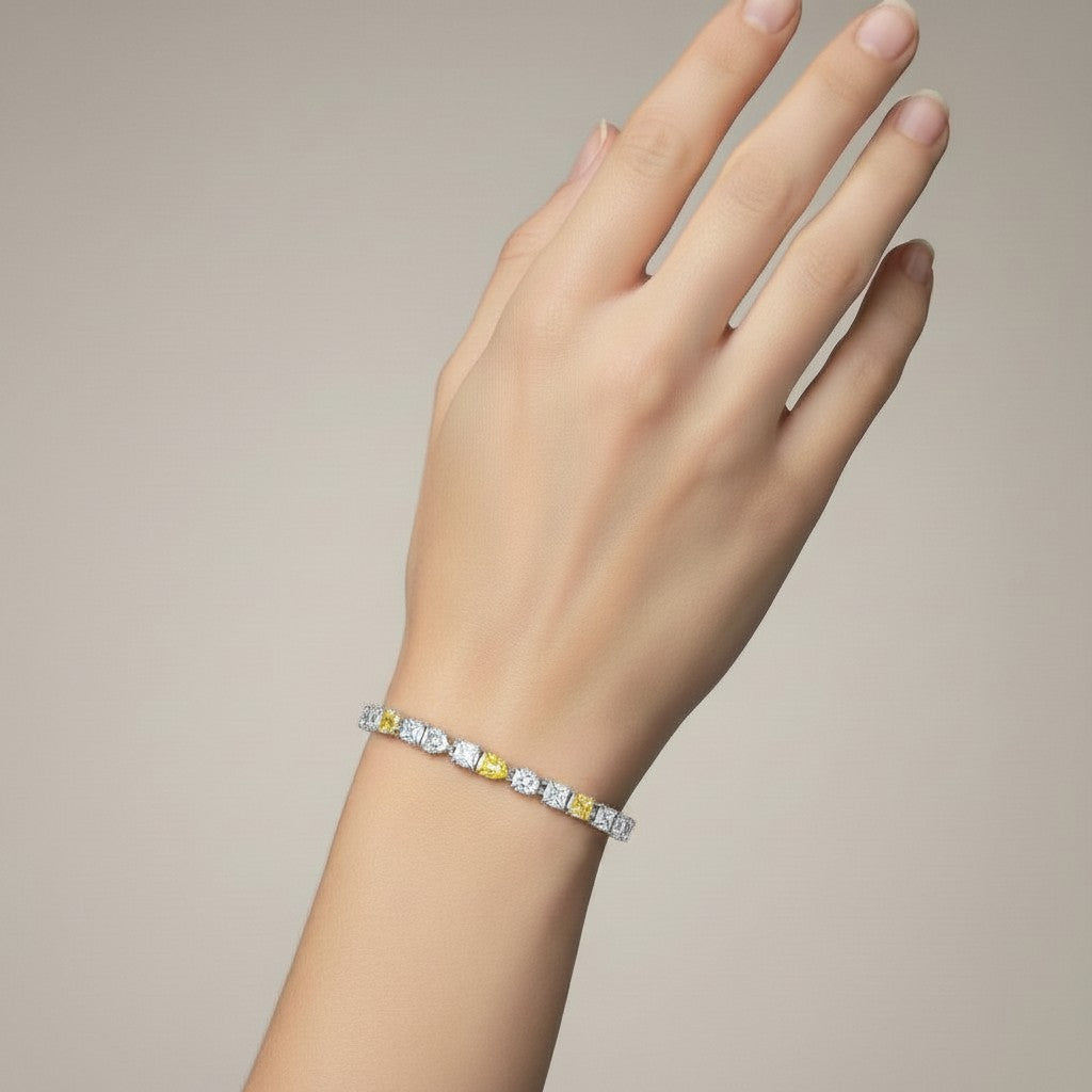 My Store 4 two-tone tennis bracelet featuring alternating fancy yellow cushion and white pear-cut diamonds on a wrist.