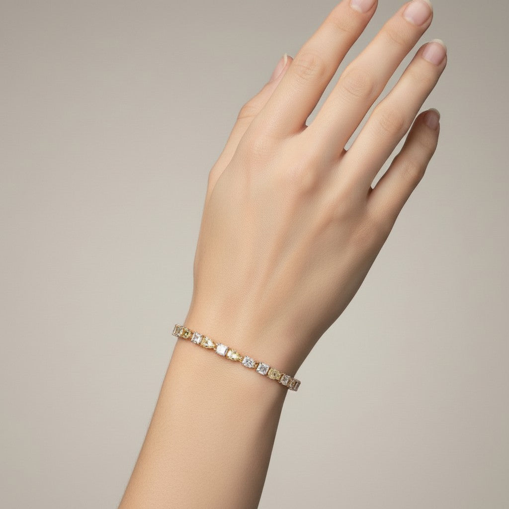 My Store 4 two-tone tennis bracelet featuring alternating fancy yellow cushion and white pear-cut diamonds on a wrist.