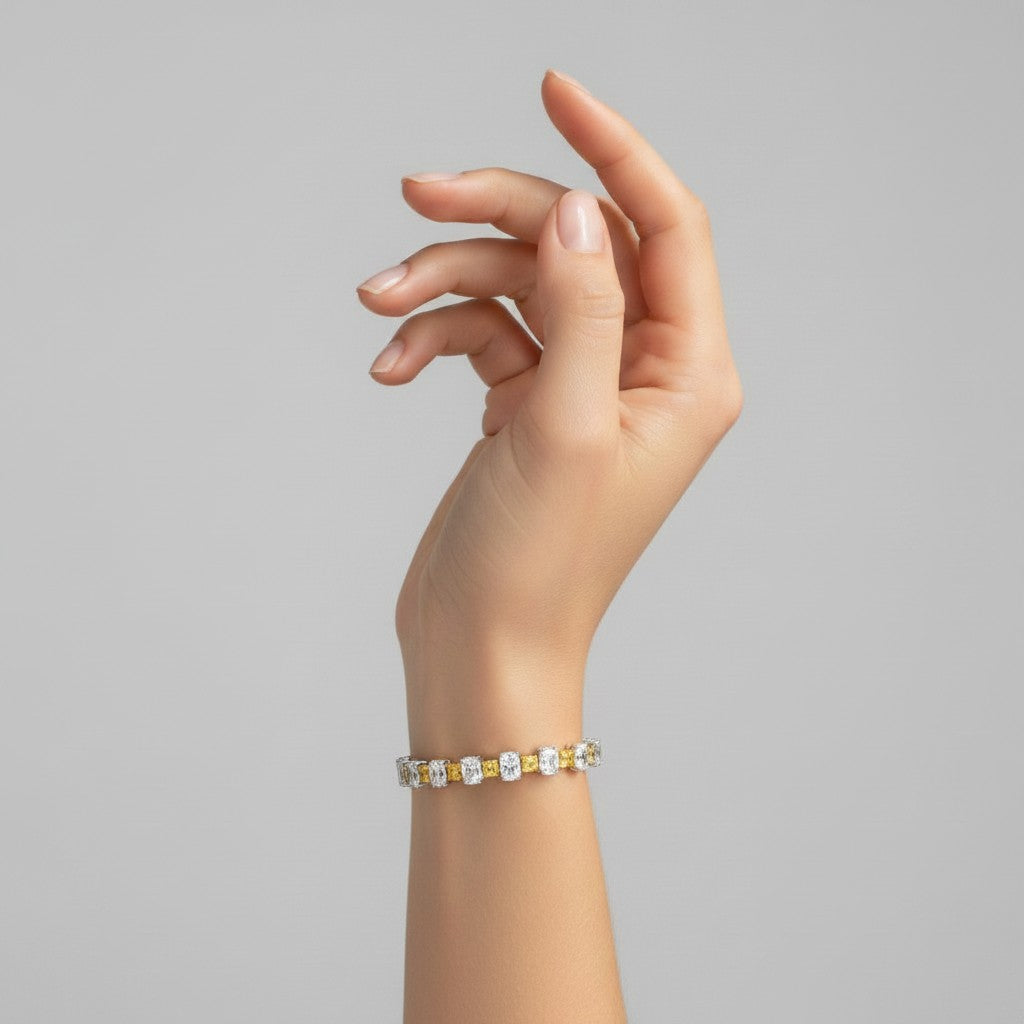 My Store 4 two-tone tennis bracelet with alternating fancy yellow cushion and white oval diamonds on a model wrist.