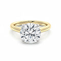 My Store 4 two-tone gold engagement ring with a round brilliant-cut solitaire diamond on a high-polish yellow band.