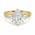 My Store 4 vintage pear cut three-stone engagement ring in 18K yellow gold with engraved scrollwork and milgrain detail.