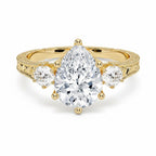 My Store 4 vintage pear cut three-stone engagement ring in 18K yellow gold with engraved scrollwork and milgrain detail.