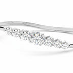 My Store 4 wave-contoured gold bangle featuring a graduated row of brilliant round diamonds in a shared-prong setting.