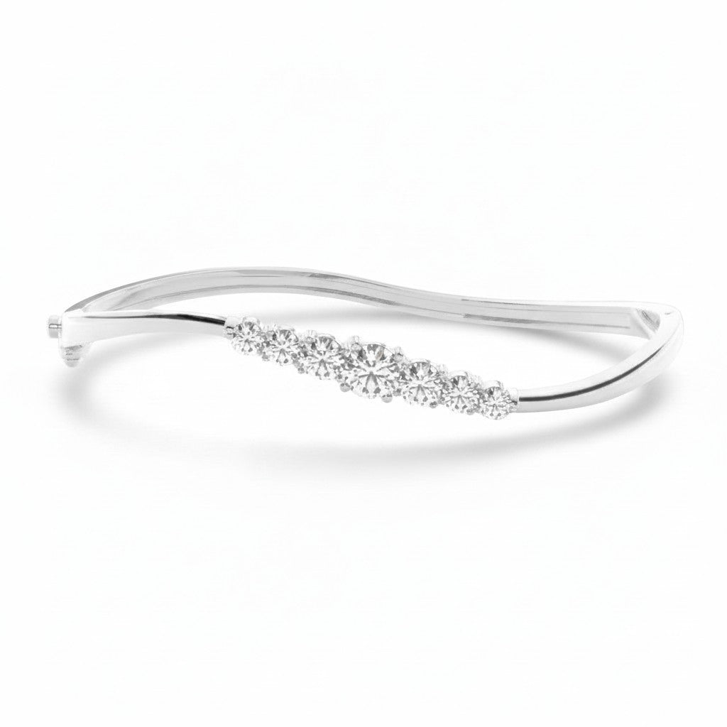 My Store 4 wave-contoured white gold bangle bracelet featuring a graduated row of sparkling round brilliant diamonds.