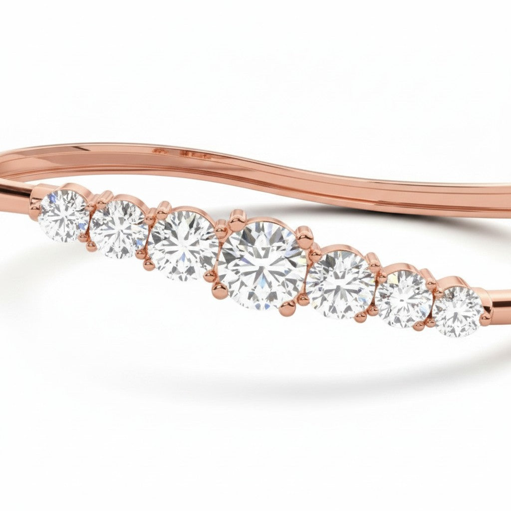 My Store 4 wave-contoured rose gold bangle featuring a graduated row of round brilliant diamonds in shared prongs.