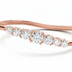 My Store 4 wave-contoured rose gold bangle featuring a graduated row of round brilliant diamonds in shared prongs.
