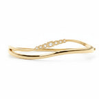My Store 4 wave-contoured yellow gold bangle bracelet featuring a graduated row of round brilliant diamonds.