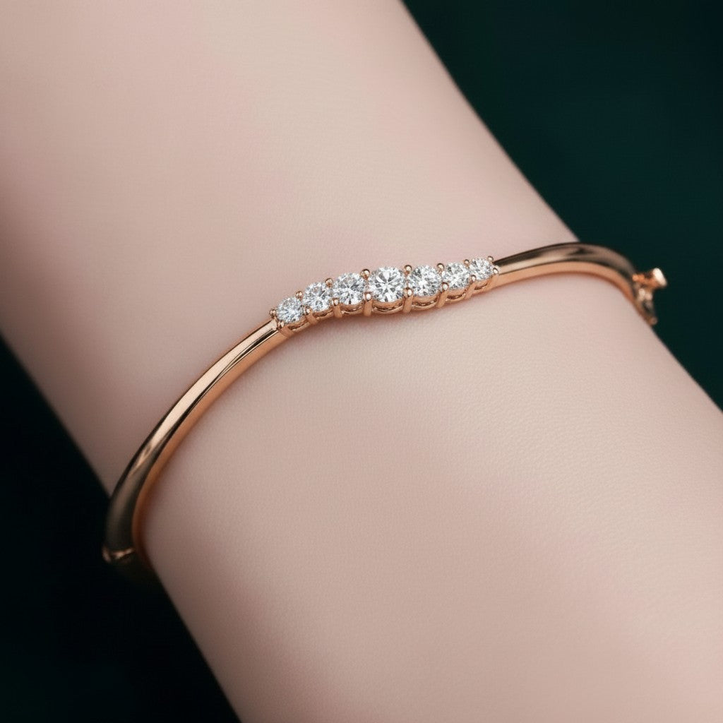 My Store 4 wave-contoured gold bangle bracelet featuring a graduated row of sparkling round brilliant diamonds.