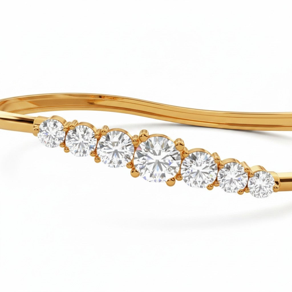 My Store 4 wave-contoured gold bangle featuring a graduated row of sparkling round brilliant diamonds in shared prongs.