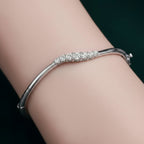 My Store 4 wave graduated diamond bangle in white gold with a hinged design worn on a wrist