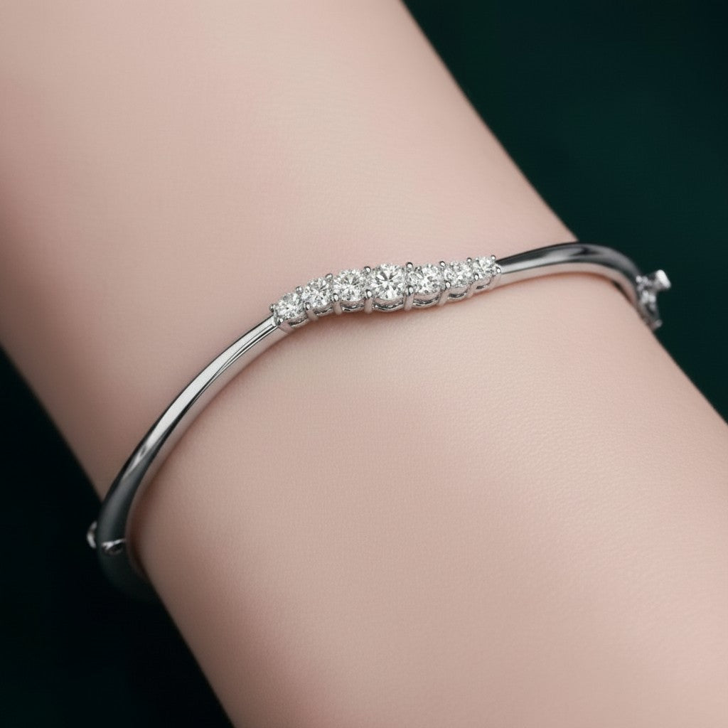 My Store 4 wave graduated diamond bangle in white gold with a hinged design worn on a wrist