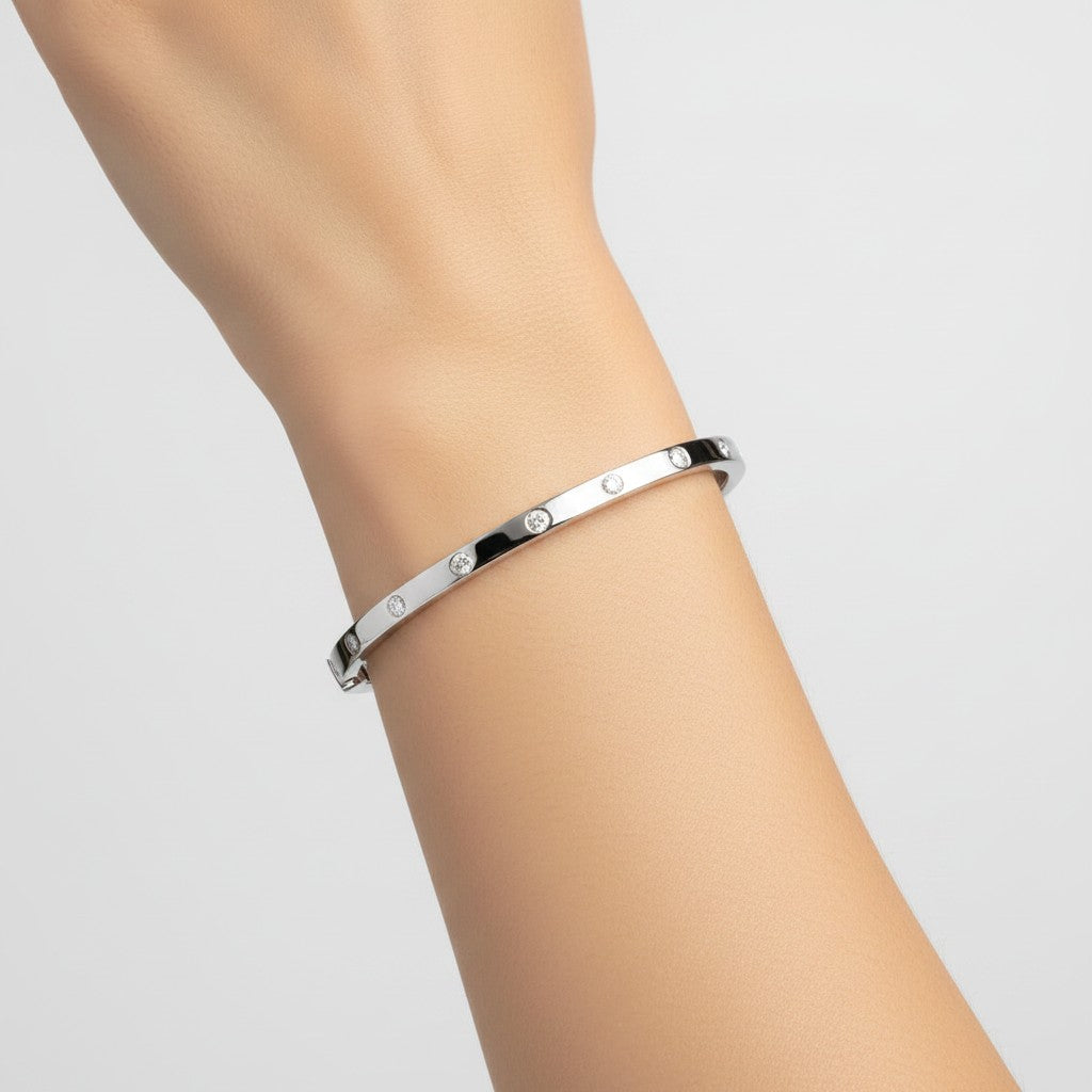 My Store 4 white gold bangle bracelet with flush-set round diamonds worn on a wrist