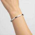 My Store 4 white gold bangle bracelet with flush-set round diamonds worn on a wrist